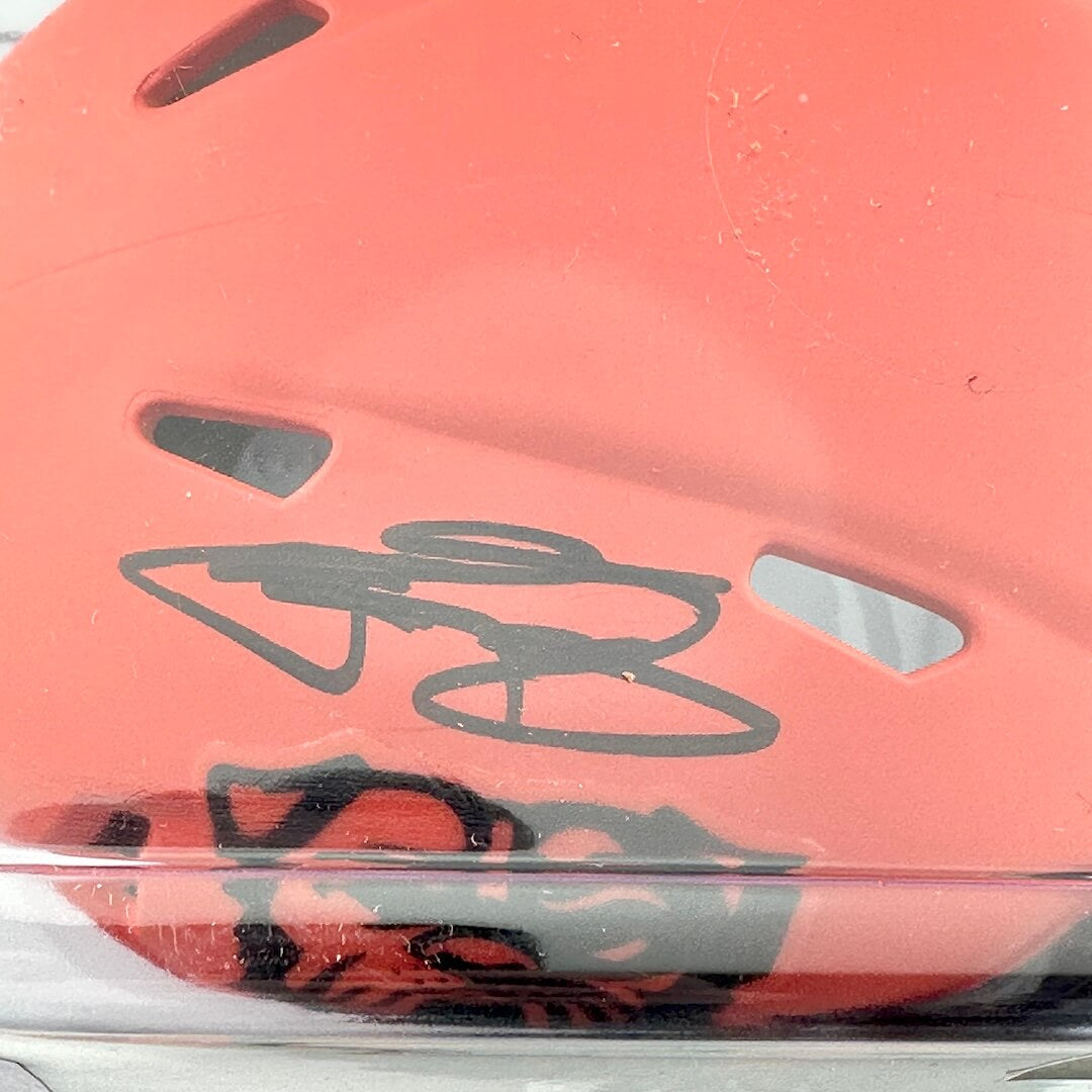 Close-up of an orange helmet with a signature on it