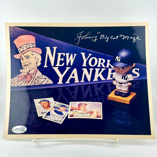 New York Yankees display with bobblehead, cards, and logo on a blue background