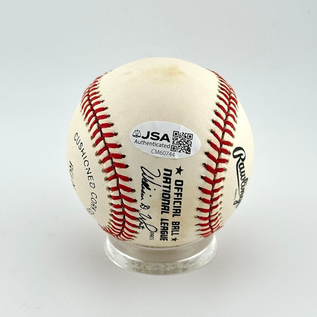 Baseball with JSA authentication label on a white background