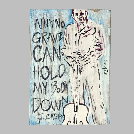Wood painted white and blue with line painting of Cash next to quote, "Ain't no grave can hold my body down."