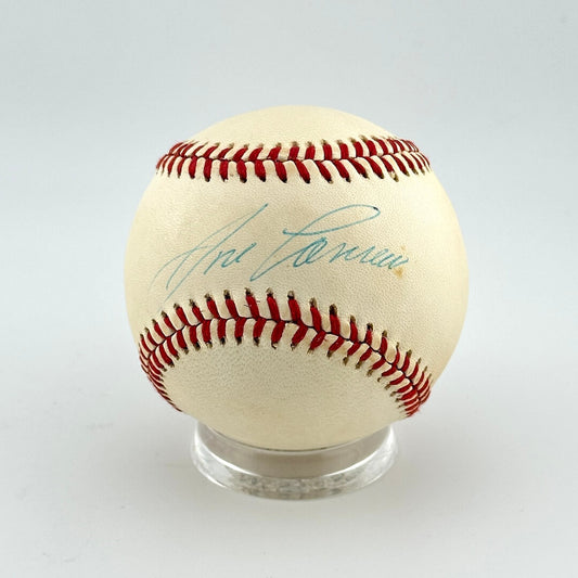 Baseball with autograph on a clear stand against a light gray background