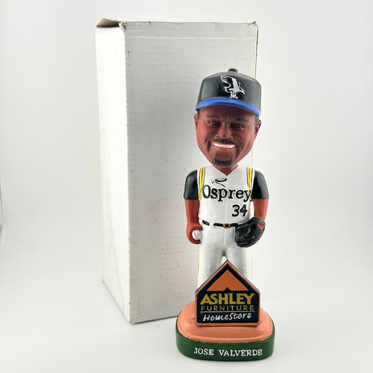 Bobblehead of baseball player in white and black uniform with box on white background. 
