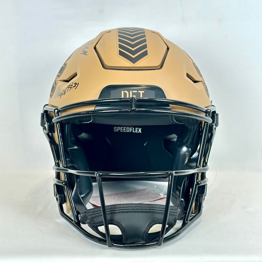 Football helmet with brown top and black face guard on a white background