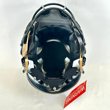 Black protective helmet with gold accents on a white background