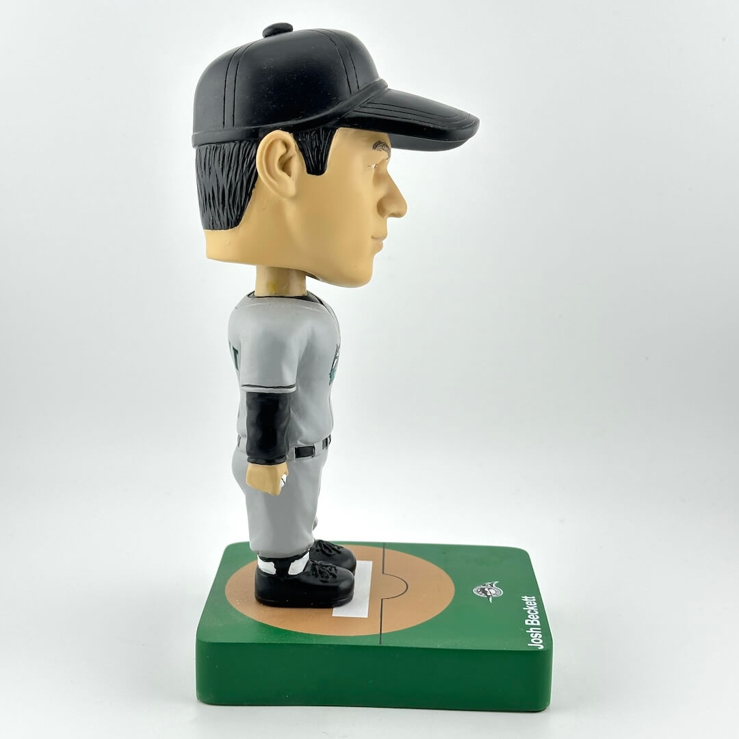 Bobblehead figure of a baseball player on a base with a white background