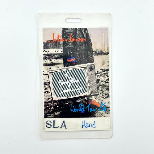 ID badge featuring a photo of Julian Lennon with a television and his band name in orange script. 