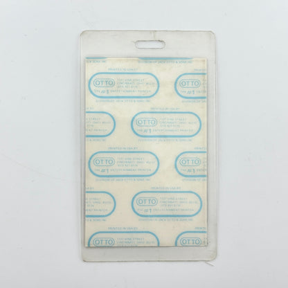backside of badge to show intact paper backing and mint condition inside lamination. 