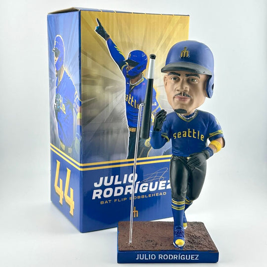Bobblehead of baseball player in blue and black uniform with bat and packaging on white background. 