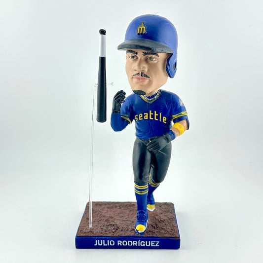 Bobblehead of a baseball player in a blue uniform with a bat on a white background
