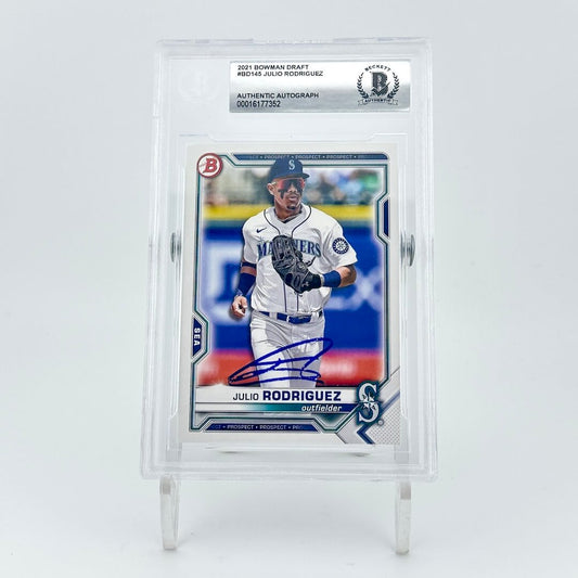 Baseball trading card of a player in a white uniform with a blue cap, encased in a clear holder on a light gray background.