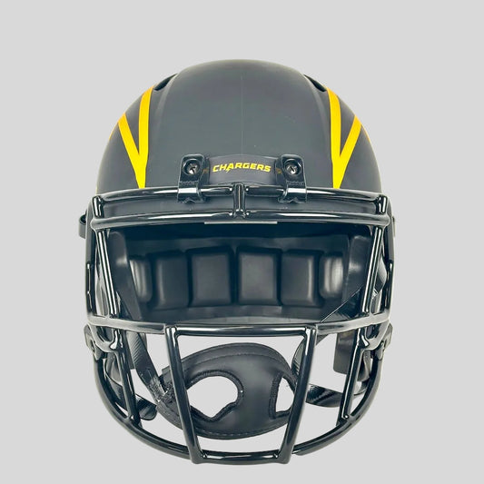 A black football helmet with yellow stripes on the sides and a black faceguard.