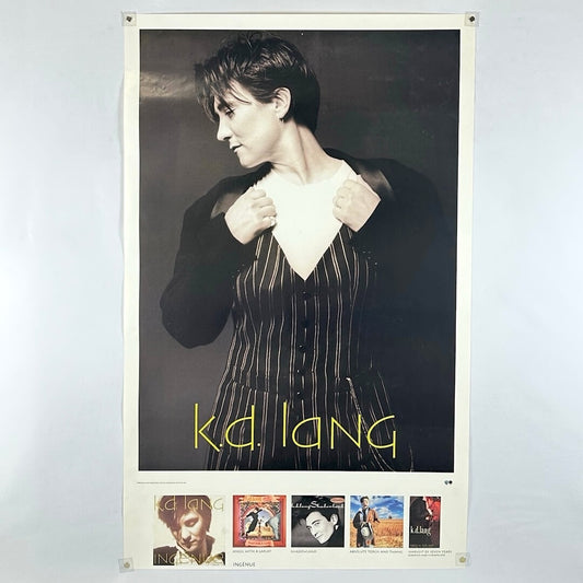 Poster with image of K.D. Land in striped jumpsuit holding lapels, with album artwork along bottom. 