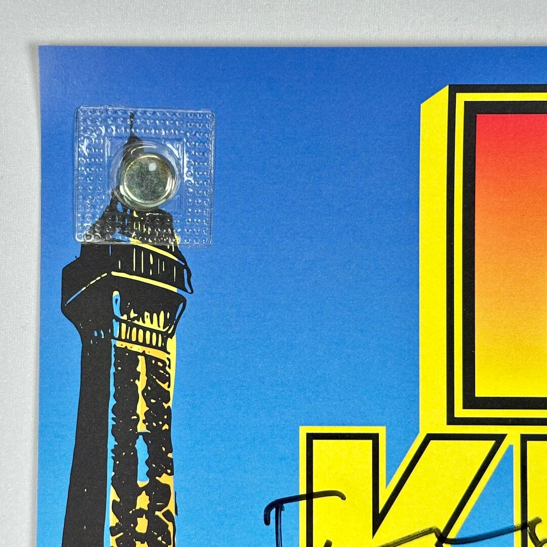 Top left corner of poster with crisp corner and clean edges. 