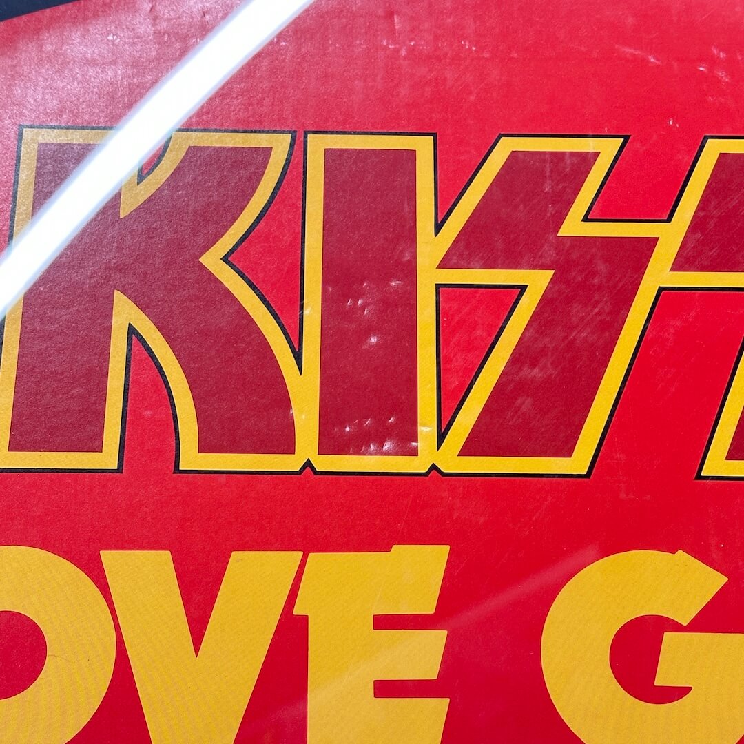 Close-up of a red and yellow 'Kiss' logo on a product packaging.