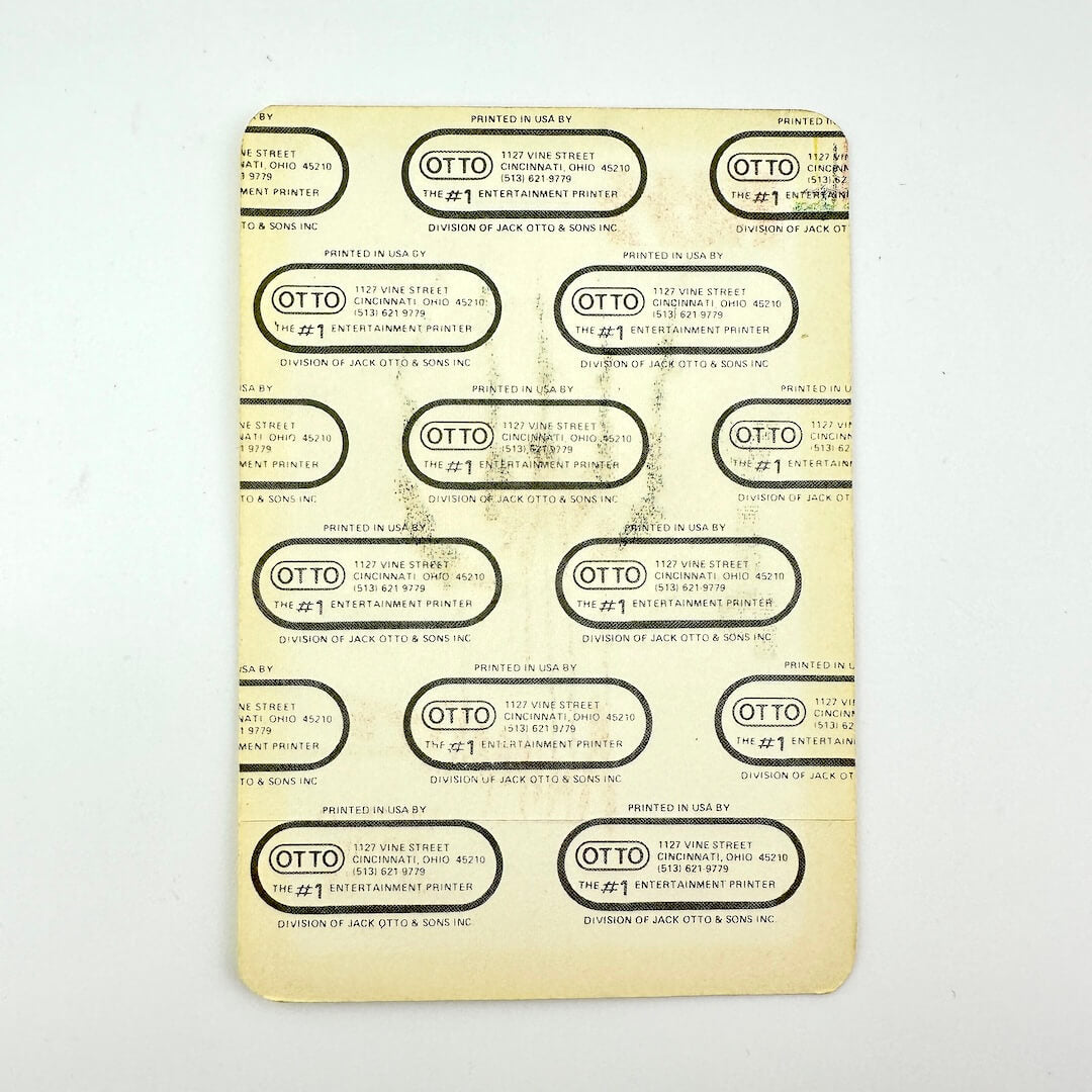 Reverse side of pass showing backing intact against white background. 
