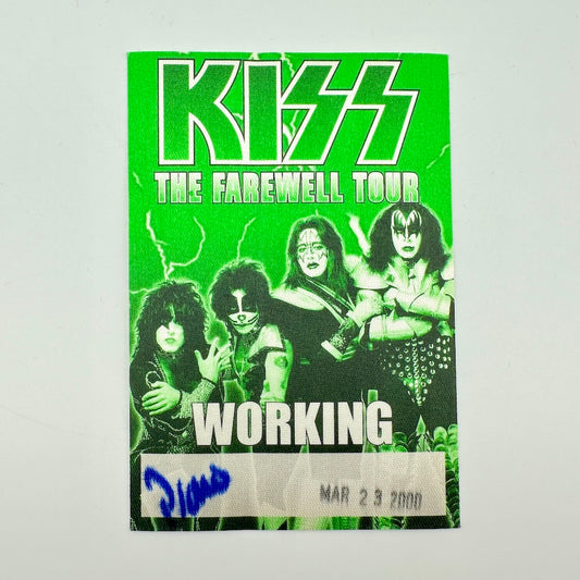 Vintage backstage pass with green background and image of KISS in center with tour name at top. 