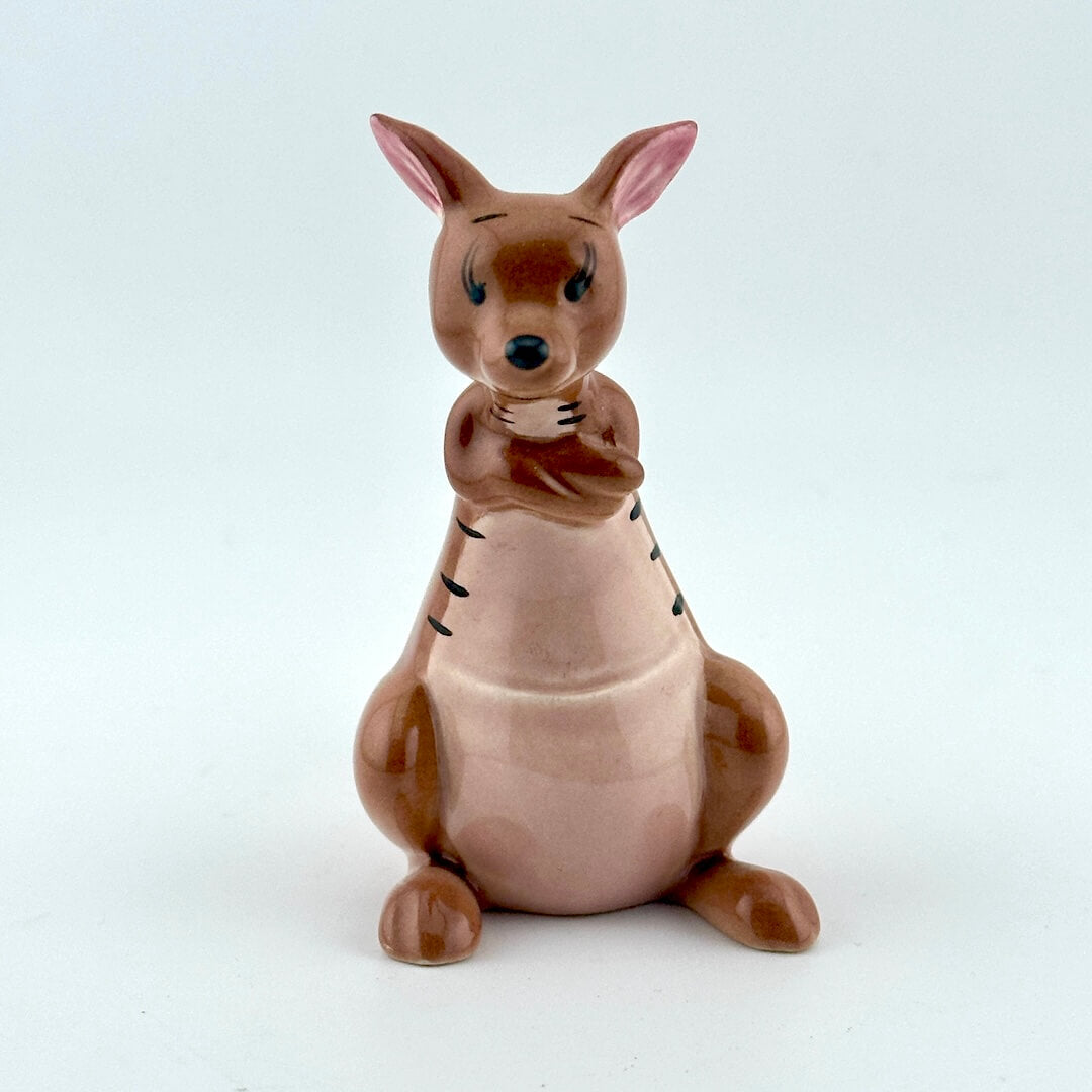 A ceramic kangaroo figurine in shades of brown and pink, sitting against a plain light gray background.