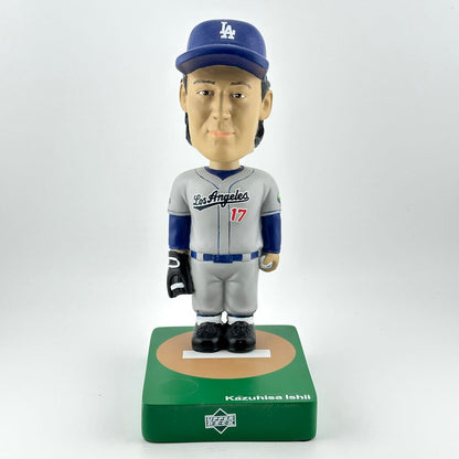 Bobblehead figure of a baseball player in a gray and blue uniform with a cap, on a white background.