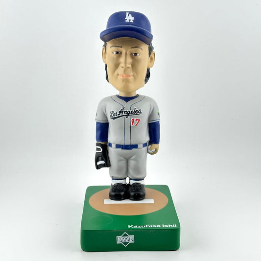 Bobblehead figure of a baseball player in a gray and blue uniform with a cap, on a white background.