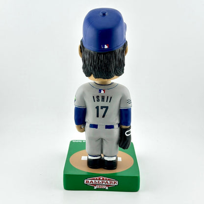 Baseball bobblehead figure with blue helmet and gray uniform on a white background