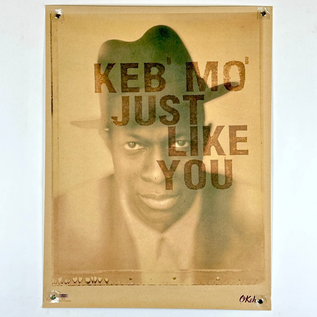Poster with a stylized portrait and text 'KEB' MO' JUST LIKE YOU' on a beige background
