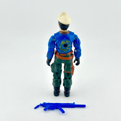GI Joe action figure with blue jacket, green pants and white hat, pictured with blue accessory on white background.
