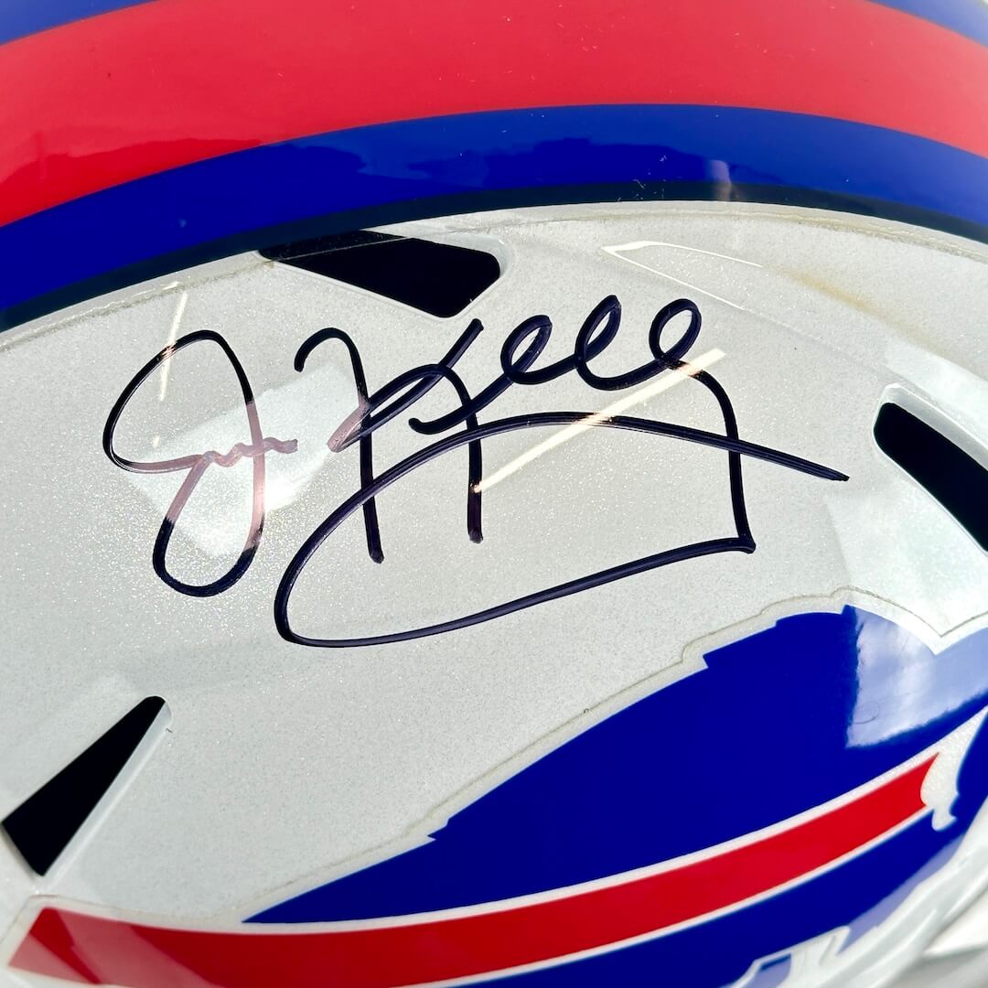 Close-up of a sports helmet with a signature on a white background