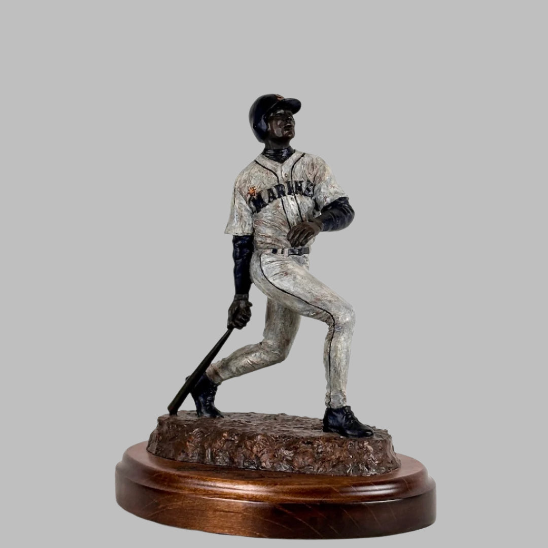 Front-side view of Ken Griffey Jr. bronze statue of him posed at the end of a swing, his signature etched into wooden base.