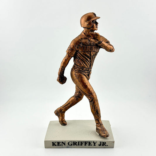 Bronze statue of a baseball player on a white background