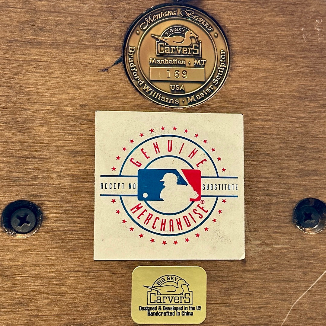 Close up of stickers on the bottom of base, showing MLB official sticker, & maker's sticker & medallion.