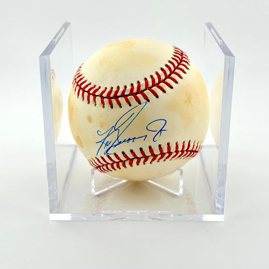 Signed baseball in clear display cube against white background. 