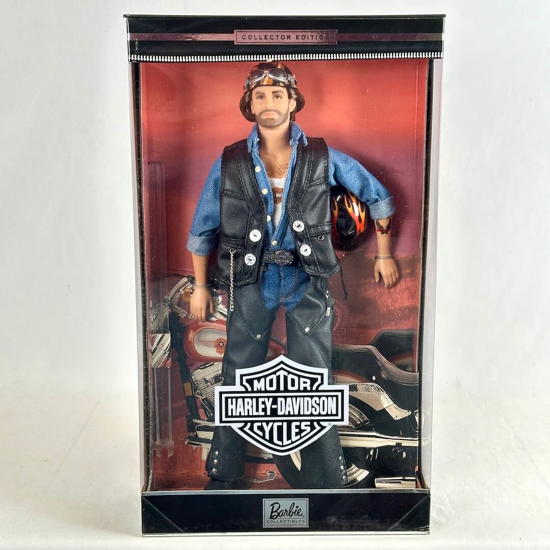Barbie Collector's Edition Harley-Davidson toy motorcycle doll, featuring a male figure in blue denim and black leather. 