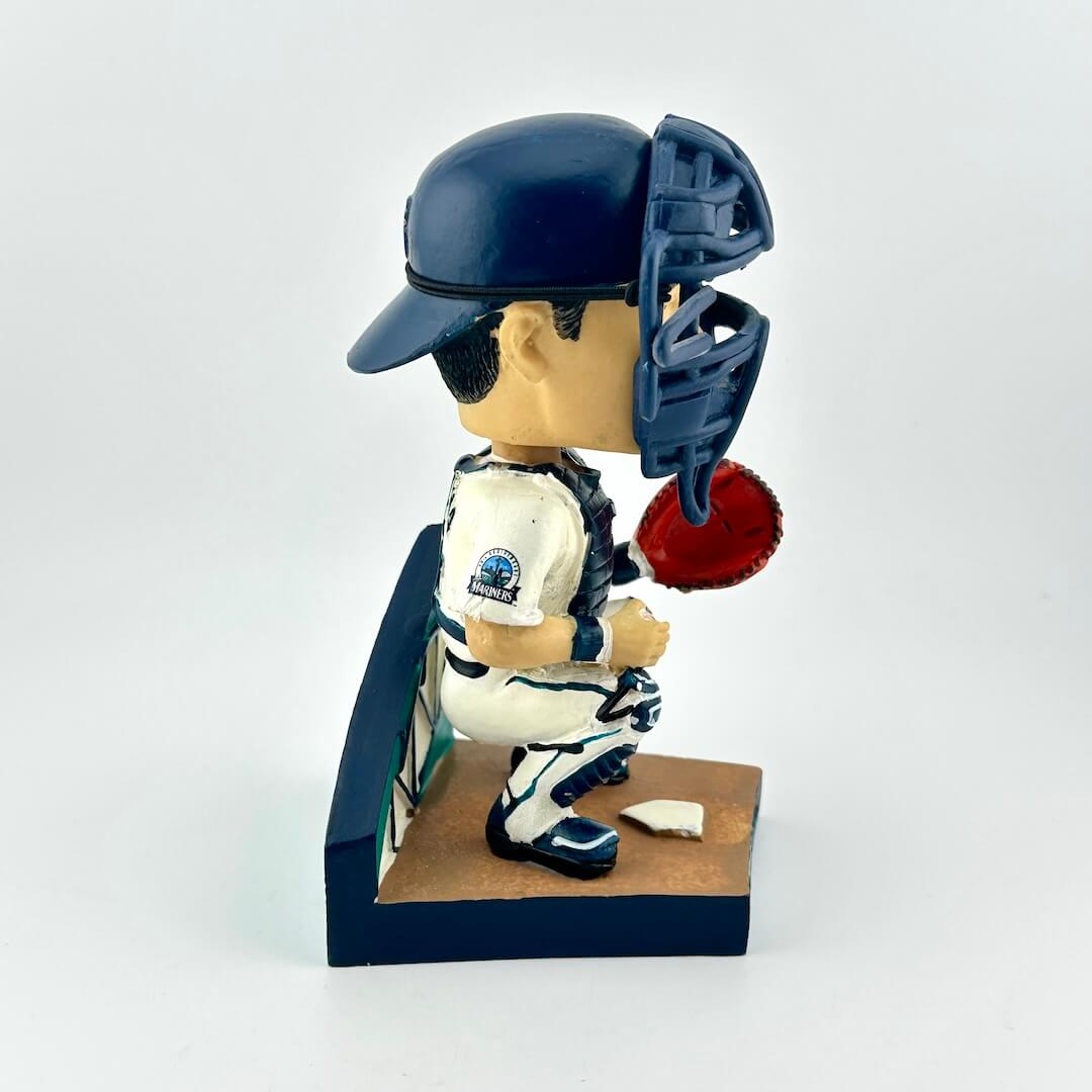 Baseball bobblehead figure with helmet and bat on a white background