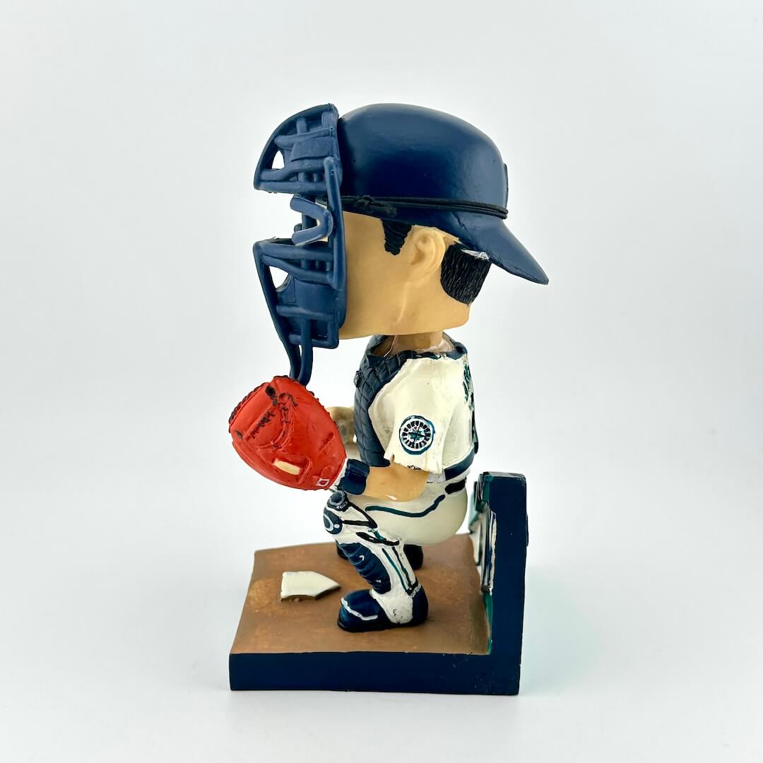 Baseball player figurine with helmet and glove on a white background