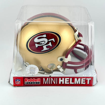 San Francisco 49ers mini helmet in clear packaging with Riddell Sports branding.