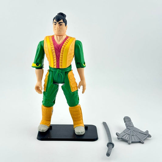 Action figure in green and yellow outfit with accessories on a white background