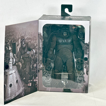 Action figure in packaging with cityscape background