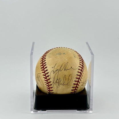Autographed baseball in plastic cube with half of cube removed to show clear signatures.
