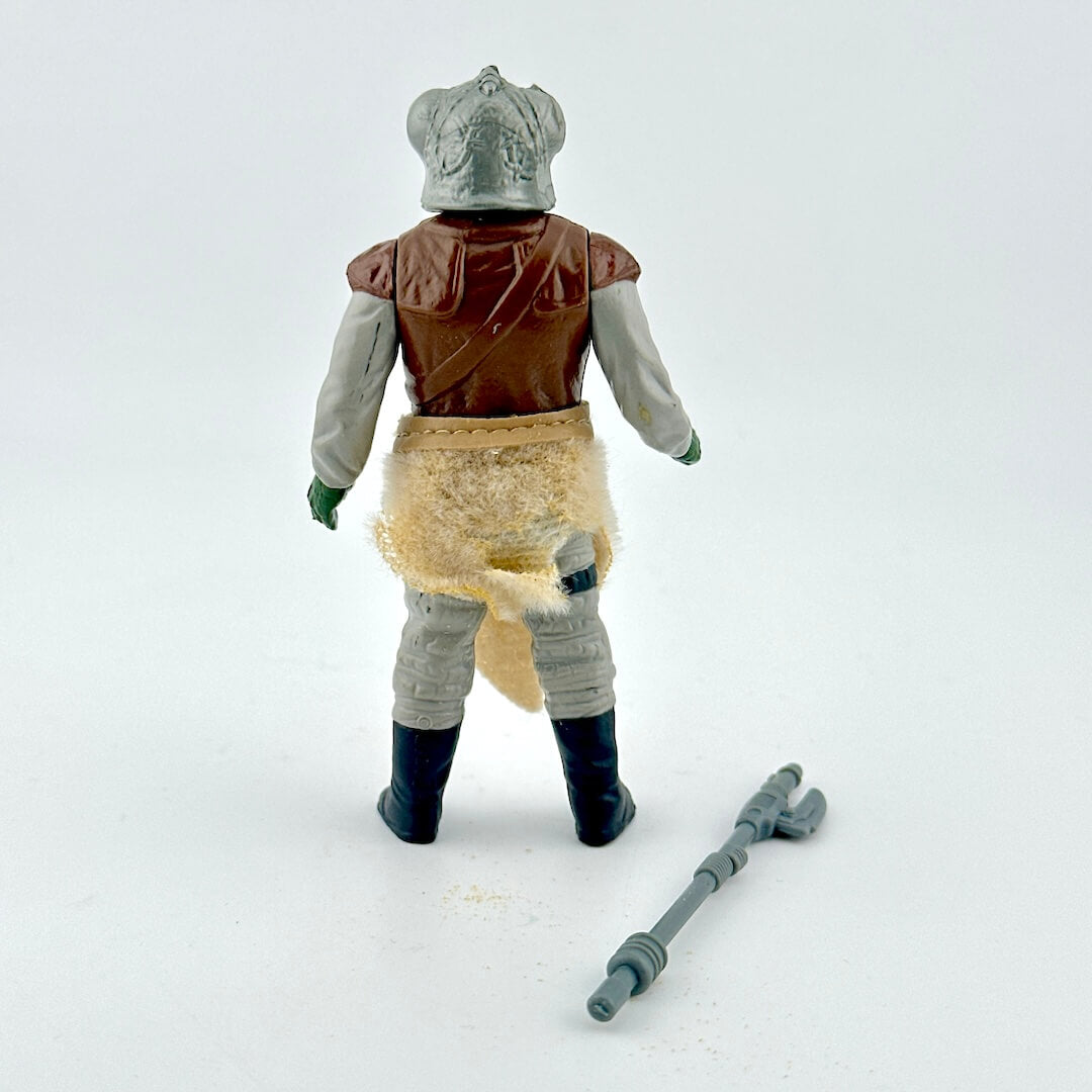 Alien action figure with accessory on white background. 