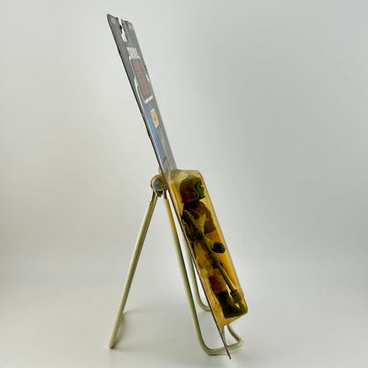 Side view of Star Wars action figure still in packaging on easel against white background.