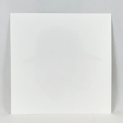 Reverse side of print showing no damage to face or edges. A plain, white square paper on a white background. 