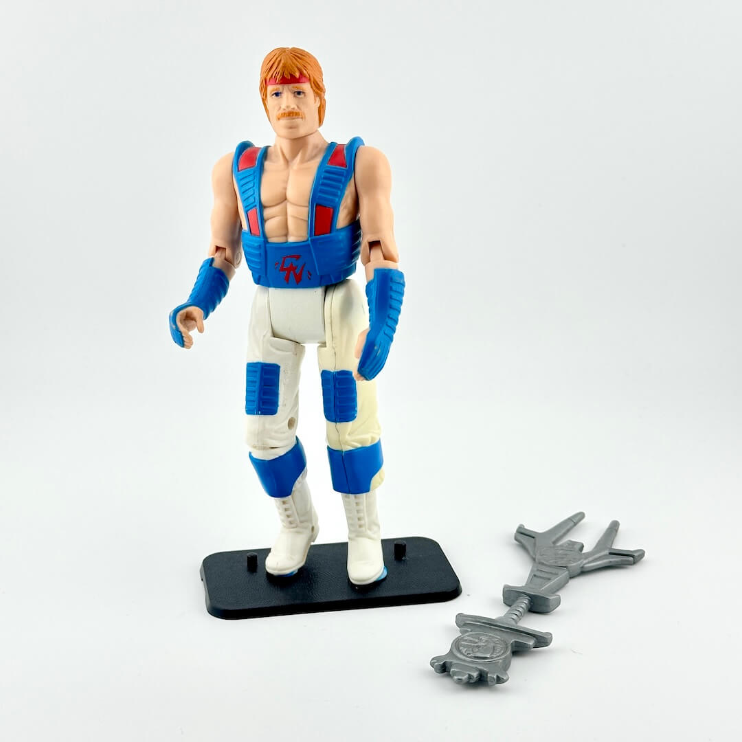 Action figure in white and blue martial arts uniform with red accents with accessory against white background.
