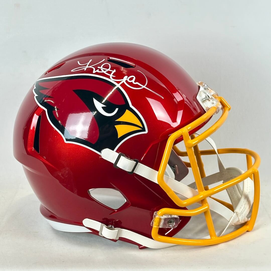 Red and yellow football helmet with "Cardinals" logo and signature. 