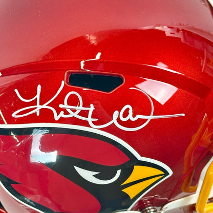 Close-up of silver signature on red helmet. 