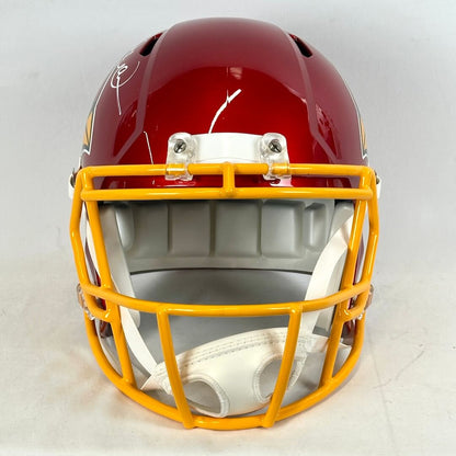 Front view of red football helmet with yellow face shield. 