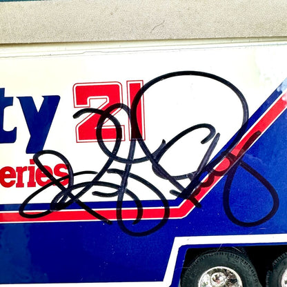 Close-up of a signature on a racing car decal with visible branding.