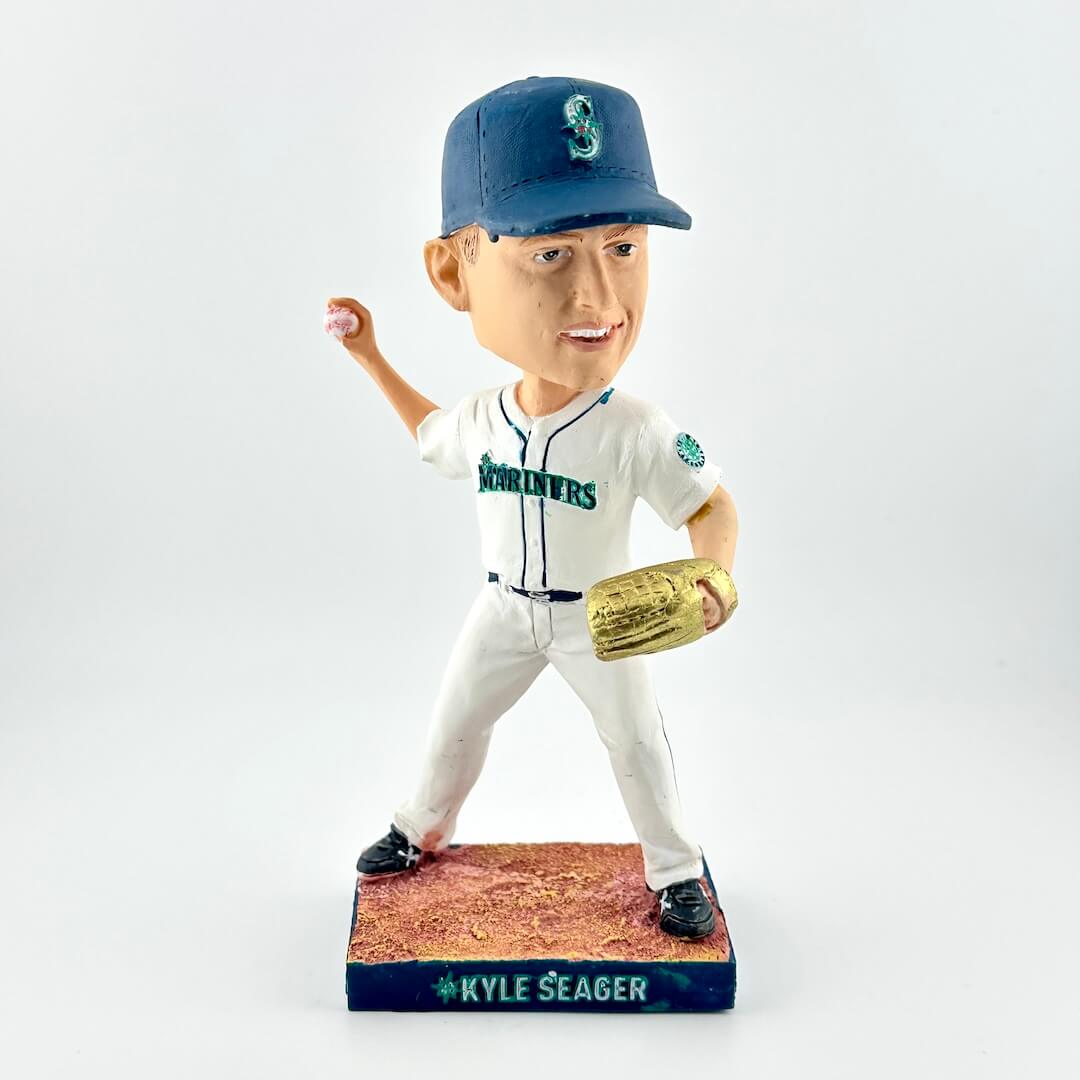 Bobblehead figure of a baseball player in a white uniform with blue cap and gold glove, on a white background.