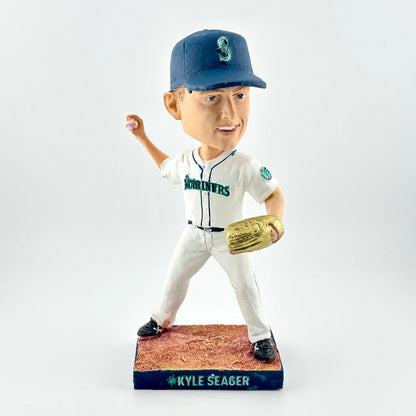 Bobblehead figure of a baseball player in a white uniform with blue cap and gold glove, on a white background.