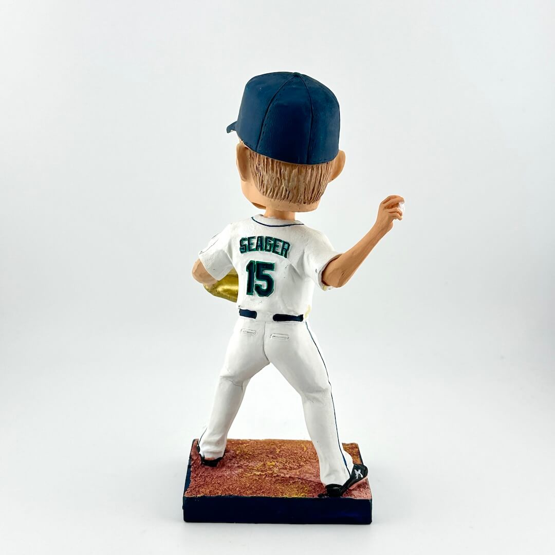 Bobblehead of a baseball player in a white uniform with blue cap on a white background