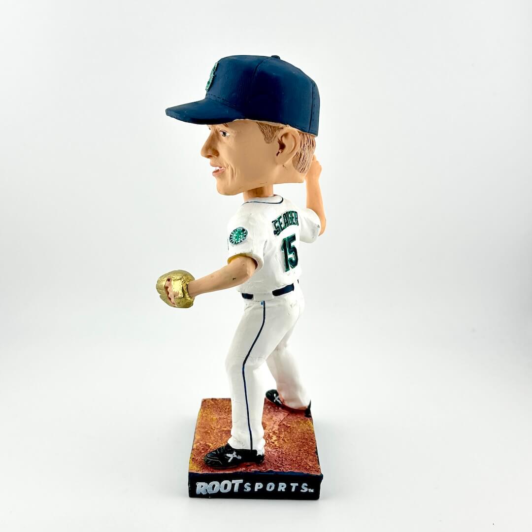 Baseball player bobblehead figure with a white uniform and blue cap on a white background